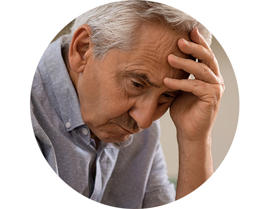 image shows man holding his hand to his head