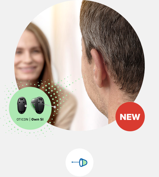 A man wearing a discreet Oticon hearing aid engages in conversation with a blurred individual in a clinical setting. The image highlights *Oticon Own SI* hearing aids with a 'NEW' label.
