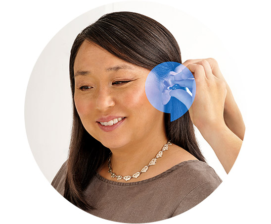 A person is fitted with a hearing aid by an audiologist in a professional setting. The focused illustration highlights the ear canal and hearing aid placement process.