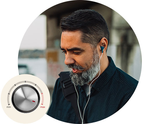 A man with blurred facial features listens through wired earphones outdoors near architectural structures. Inset: A circular volume knob labeled 'min' to 'max' with a red indicator.