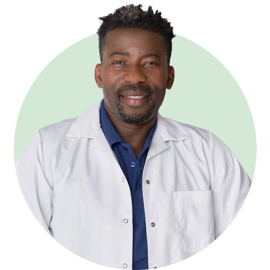 Audiologist wearing a white coat against a light green background