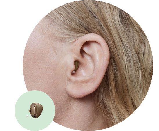 Completely-in-the-canal hearing aid fitted snugly in ear