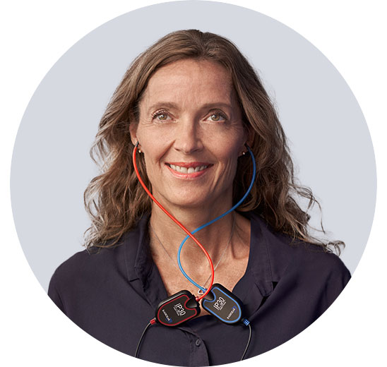 Kobieta z urządzeniem do testowania słuchu w kolorze czerwonym i niebieskim.