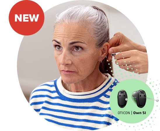 Osoba starsza w paskowanym swetrze jest dopasowywana do aparatu słuchowego Oticon Own S1™ przez audiologa. Obok znajduje się tekst i wizualizacja aparatu słuchowego.