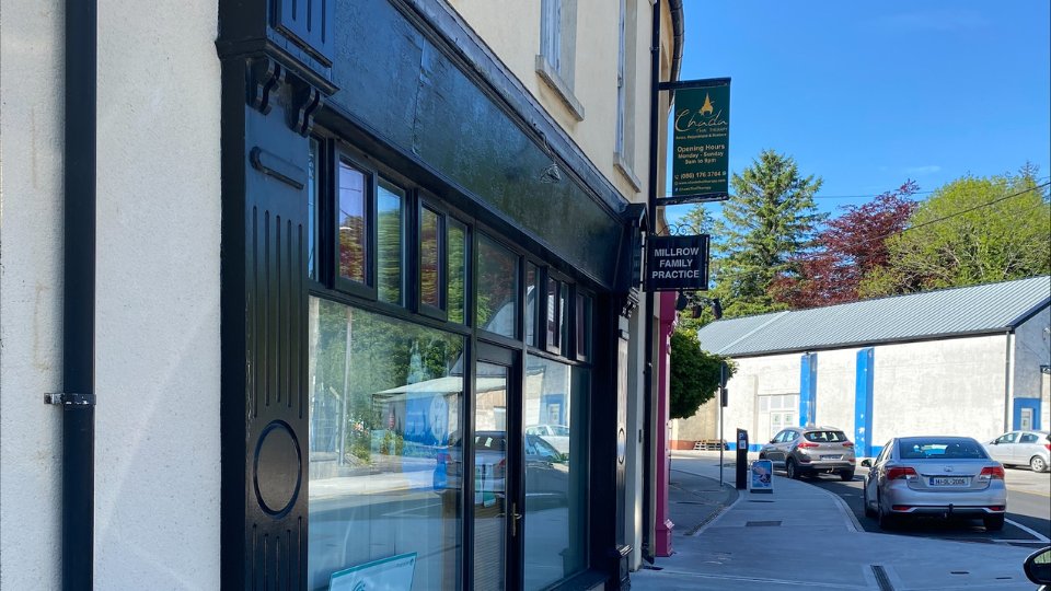 hearing care clinic storefront in Donegal town center with clear signage and adjacent street view